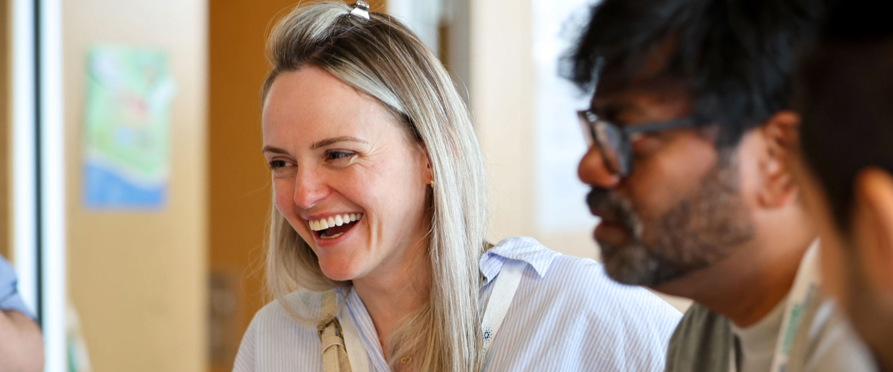 An image of two Kronos Foundation employees laughing.