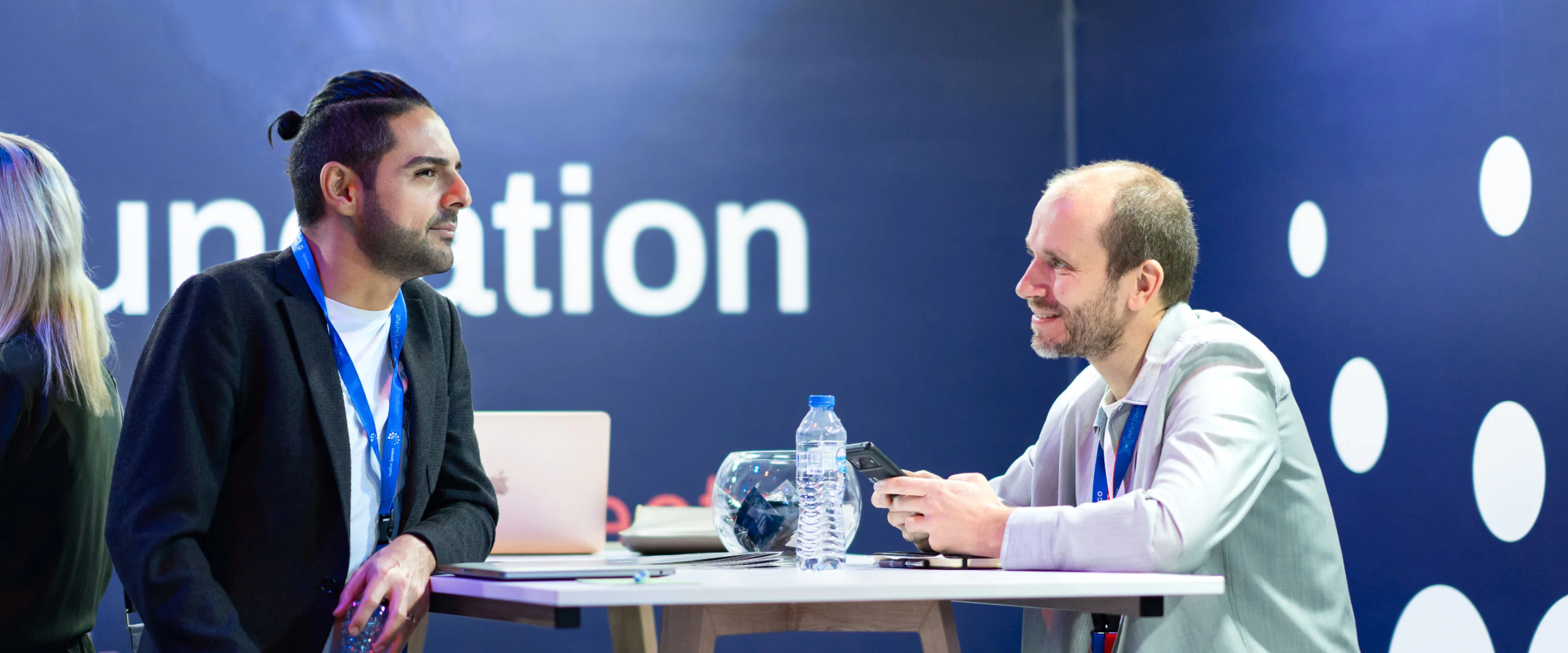 An image of CF employees engaged in conversations at the CF booth. 